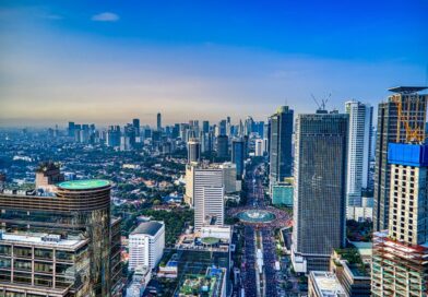A breathtaking aerial view of Jakarta's urban skyline during the day, showcasing skyscrapers and city life.