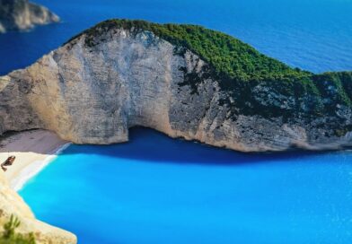 A breathtaking aerial view of Navagio Beach in Zakynthos, Greece with turquoise waters and dramatic cliffs.